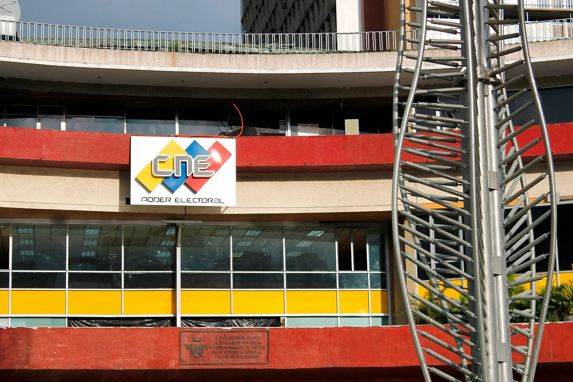 Facade of the National Electoral Council building in Caracas, with the red, yellow and blue CNE "Poder Electoral" sign.