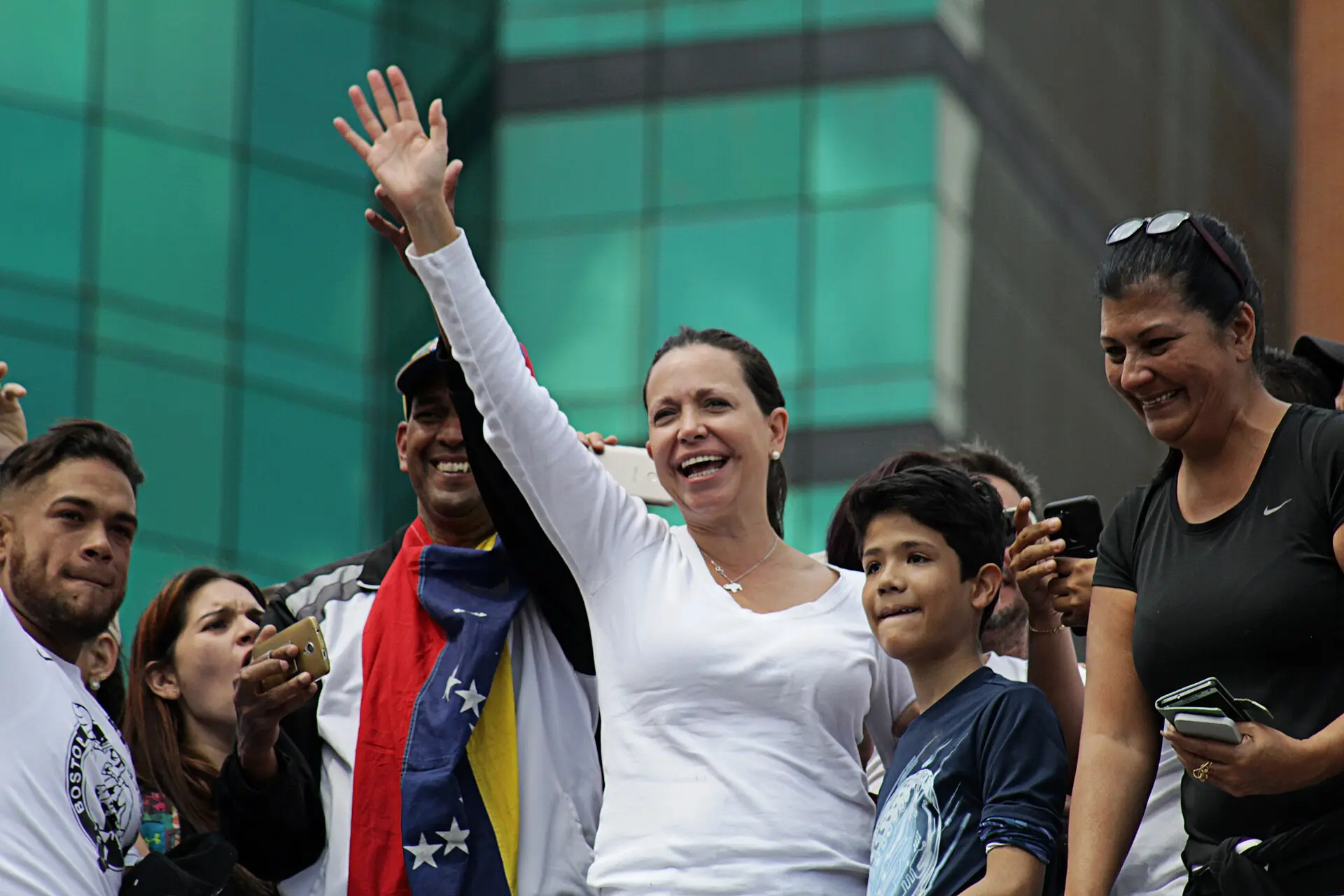 María Corina Machado waves from among supporters during an opposition march in Caracas.